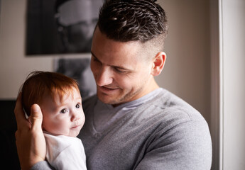 Father, baby and pride with hug for bonding, love and happiness with child development and parenting. Peace, calm and childhood with smile, man and newborn kid for tender moment at family home