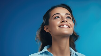 A woman happily looking up at the sky. Suitable for various concepts - obrazy, fototapety, plakaty