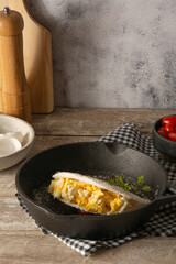 Tapioca Pancake with eggs Brazilian manioc food in top front view inside steel skillet pan
