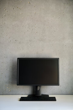 Computer monitor with blank black screen on the desk with copy space.