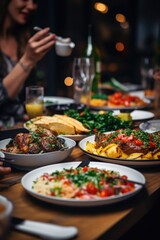 A group of people sitting at a table with plates of food. Perfect for illustrating social gatherings