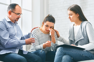 Understanding people calming crying woman during group session meeting in rehab