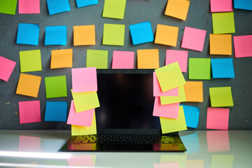 Office workplace with laptop and blank colorful sticky notes reminders - 762347621