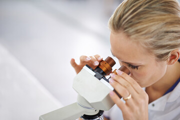 Woman, research and scientist with microscope for exam, test or scientific discovery at laboratory....