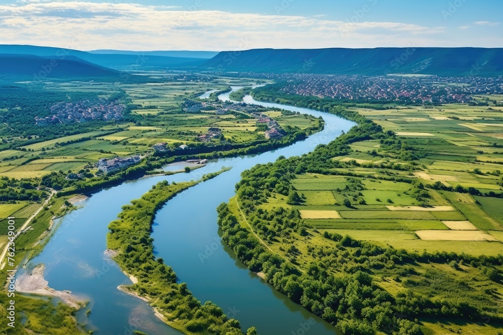 Poster scenic view of a river flowing through a lush green valley. perfect for nature and landscape concept
