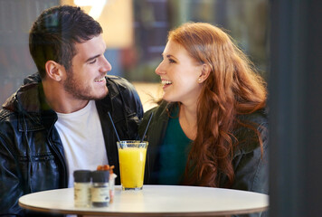 Couple, smile and eye contact in restaurant with love, romance and affection on anniversary date....