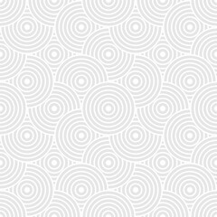 Seamless trendy pattern of circles and arcs, geometric white shapes for textiles and wallpaper. Festive Christmas pattern on a gray background.