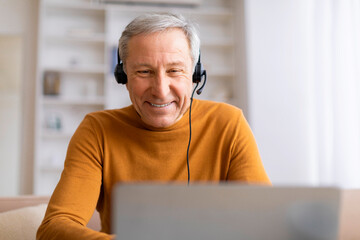 Elderly man enjoying music on headphones