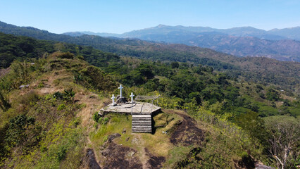 Scenic aerial landscape view overlooking crucifix statues and mountainous terrain of Mount Ramelau...