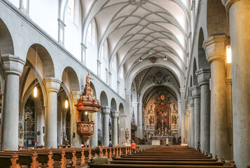 Lovely view of the Romanesque nave, vaulted in baroque style with monolithic columns from the 11th century and the pulpit from 1680, inside the famous Constance Cathedral in the old town of Constance. - obrazy, fototapety, plakaty