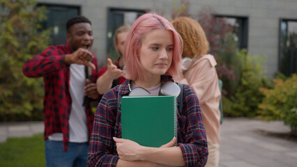 Sad stressed scared offended school girl student woman informal hipster with pink hair suffer aggressive multiracial students classmates mock abused humiliate bully mockery bullying university racism