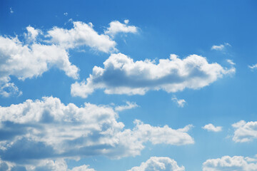 Blue sky background with fluffy white clouds