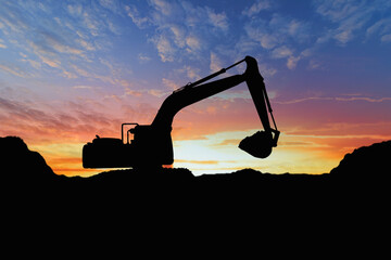 Crawler excavators silhouette are digging the soil in the construction site. on  sunset background
