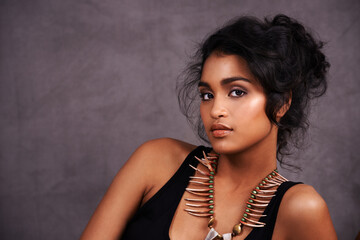 Indian woman, confident and fashion with jewelry in studio on grey background for heritage or...