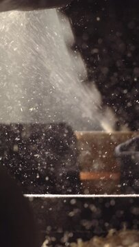 Explore the beauty of craftsmanship with this 4K vertical slow-motion footage of a circular saw slicing through wood