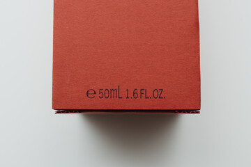 A red perfume box displaying the volume information, marked as 50ml or 1.6 fl. oz., against a clean white background