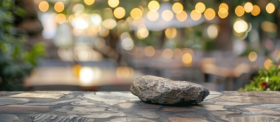 A large rock is placed on a wooden table, creating a serene still life scene with elements like grass, plants, and whiskers around - obrazy, fototapety, plakaty