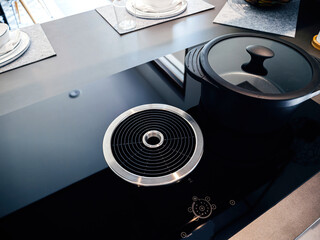 Modern induction cooktop with an innovative integrated extraction system, reflecting the seamless...