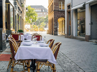Experience fine dining on a luxury restaurant terrace in Strasbourg, perfectly laid out for an...