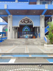 The building and entrance to the mosque are colored blue