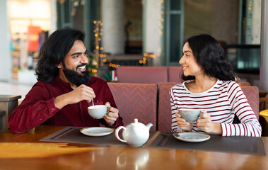 Happy young indian couple have romantic date at cafe