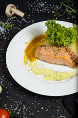 salmon in honey-soy glaze and fresh vegetable close-up on a plate. horizontal view from above