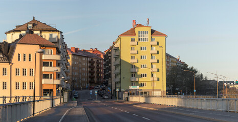 Apartment houses on the island Lilla Essingen, bridge and bus stops, an early sunny morning in Stockholm