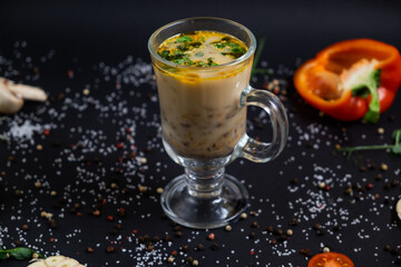 vegetarian vegetable soup with porcini mushrooms in a glass bowl on a wooden table