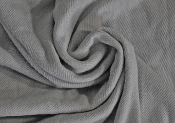 Folds of crumpled gray woolen fabric. Close-up photo, background texture