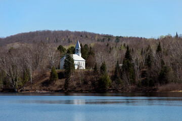 A Quebec church on a lakeshore in the spring