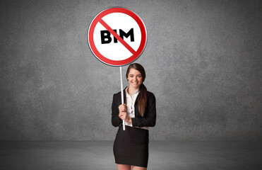 Young business person holdig traffic sign