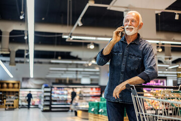Phone call, shopping and grocery with man in supermarket for food, choice and discount option at...