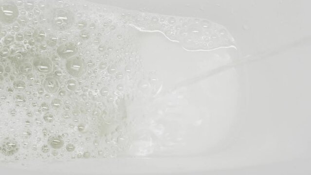 A stream of urine in a white toilet