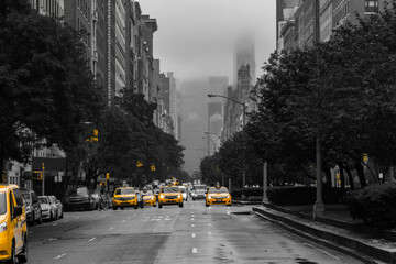 Yellow cabs isolated against a black and white view of Park Avenue on Upper East Side, New York City