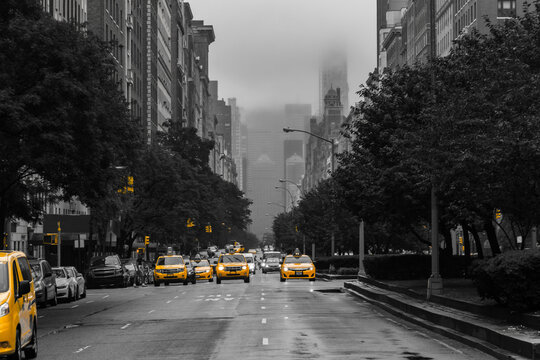 Fototapeta Yellow cabs isolated against a black and white view of Park Avenue on Upper East Side, New York City