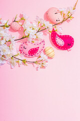 Gentle Easter composition with cherry flowers and handmade felt birds. Decorative eggs and nest
