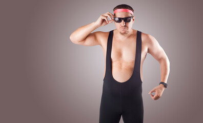 fat man in sports tights, sunglasses and headband on a