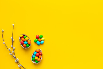 Happy Easter background with chocolate eggs and spring branch, top view - obrazy, fototapety, plakaty