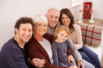 Grandparents, parents and kid on sofa for portrait with hug, care or love with generations for...
