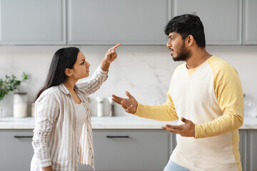 Furious millennial indian couple have fight, kitchen interior