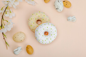 Handmade crocheted donuts with blooming cherry branches. Festive Easter, greeting card