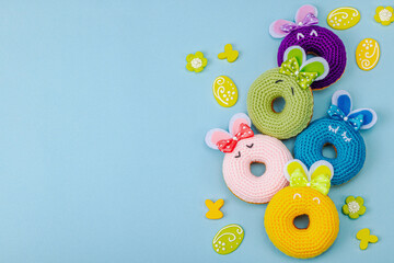 Handmade Easter concept. Crocheted donuts bunnies with traditional decoration. Festive symbols