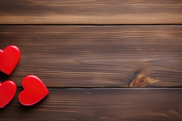 Fototapeta premium Two red hearts on a dark wooden texture, symbolizing love and romantic setting.