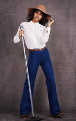 Woman, fashion and cowgirl in studio, microphone and western clothes on proud and confident singer....