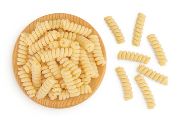 Italian spiral shaped pasta, Fusilli bucati macaroni in wooden bowl, isolated on white background....