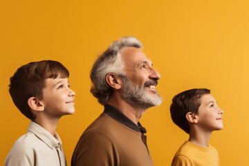 Elderly man with two young boys, all smiling and looking in the same direction, embodying happiness and shared perspective. Happy Grandfather and Grandsons Looking Forward