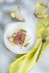 Fresh delicious salad with prosciutto, arugula with rose wine on light great marble background. Healthy diet concept. Italian cuisine. Vertical