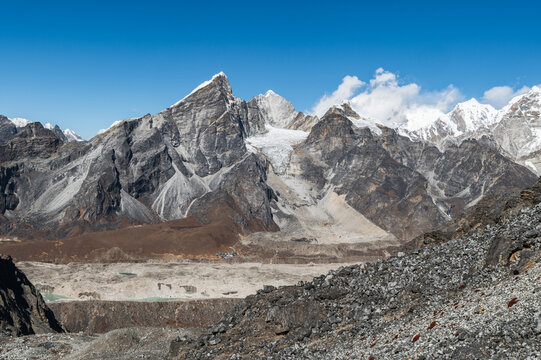 Alpine lake, Mounts Lobuche, Cho Oyu and Khumbu Glacier from Kongma La Pass during Everest Base Camp EBC or Three Passes trekking in Khumjung, Nepal. Highest mountains in the world.