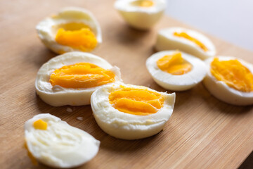 Close-up of sliced boiled eggs arranged neatly on a wooden cutting board