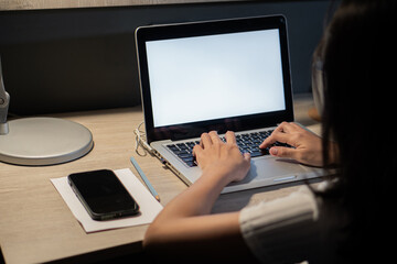 Fototapeta na wymiar Overworked female working on a laptop. Teenage girl school student doing homework at home.